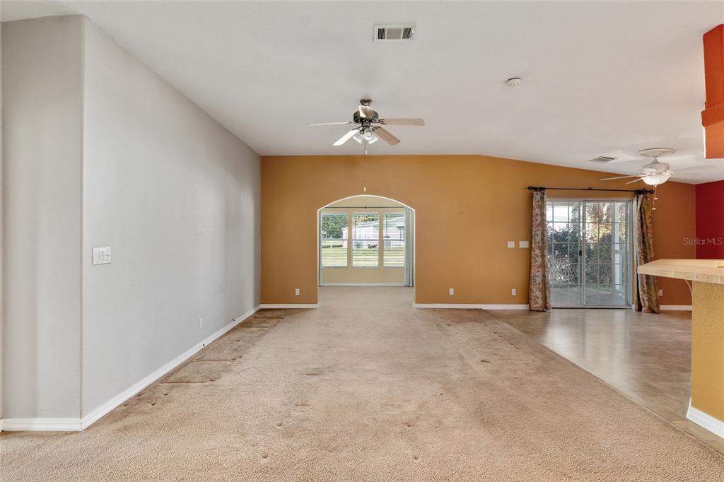 7863 Southwest 6th Place Ocala, FL 34474 - Photo 7 of 60 an empty room with chandelier fan and windows
