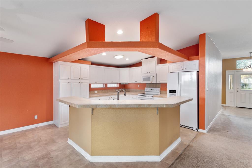 7863 Southwest 6th Place Ocala, FL 34474 - Photo 9 of 60 a kitchen with stainless steel appliances a stove a refrigerator and a dining table