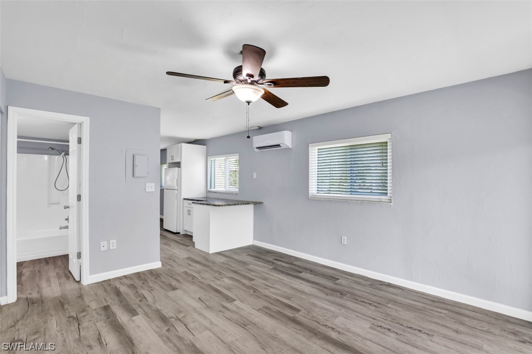 8109 Country Road, Unit 103 Fort Myers, FL 33919 - Photo 11 of 19 a view of a kitchen with wooden floor and a ceiling fan