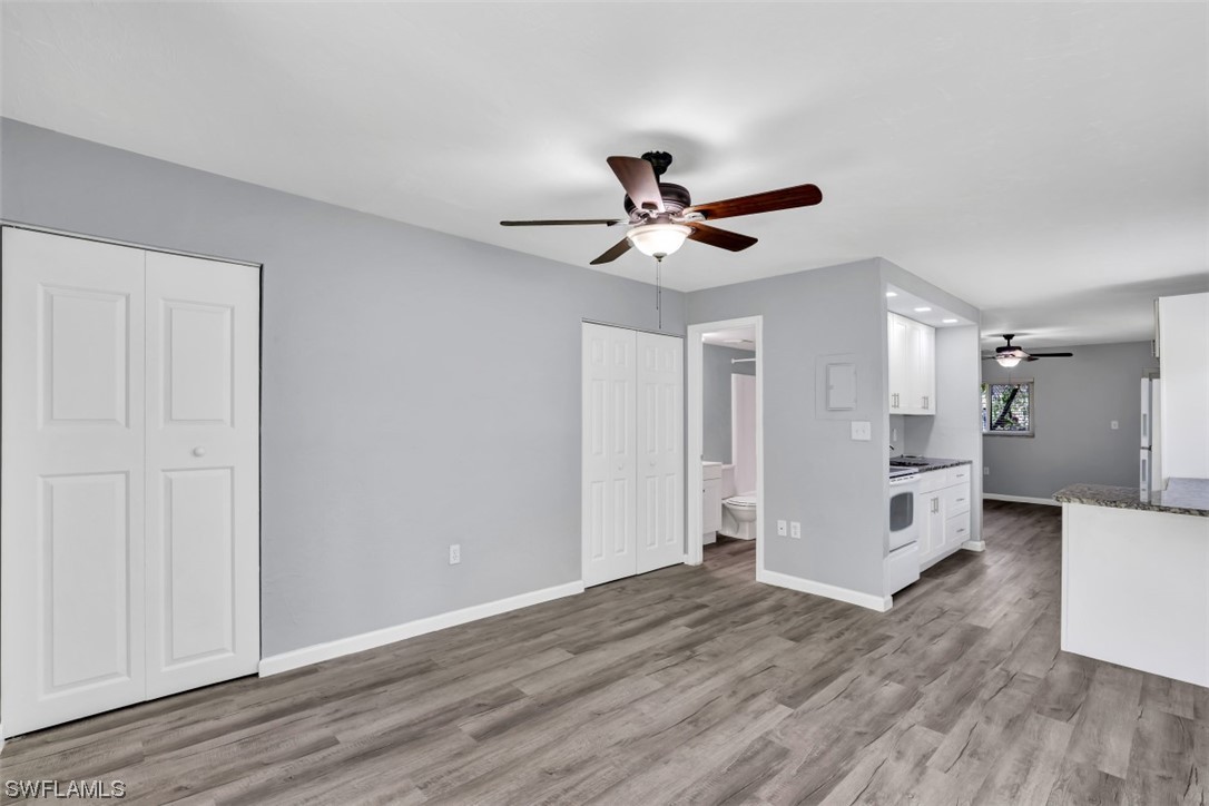 8109 Country Road, Unit 103 Fort Myers, FL 33919 - Photo 8 of 19 a view of a big room with wooden floor and chandelier fan