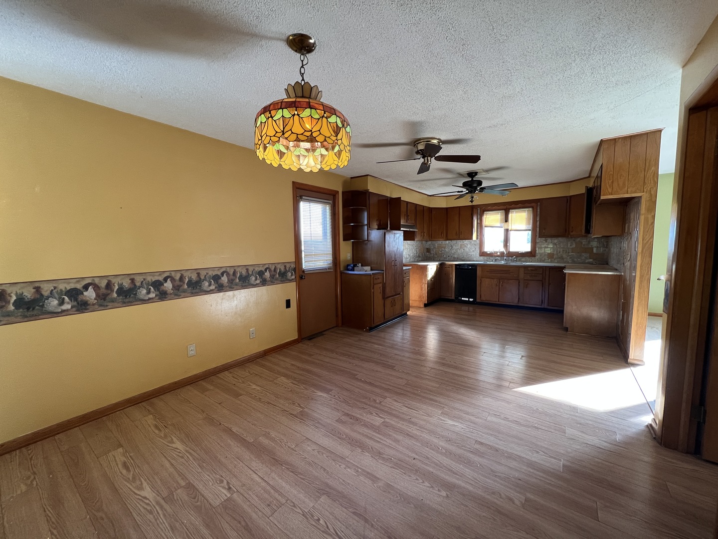 48W137 Middleton Road Maple Park, IL 60151 - Photo 11 of 27 a view of a kitchen with a fridge and wooden floor