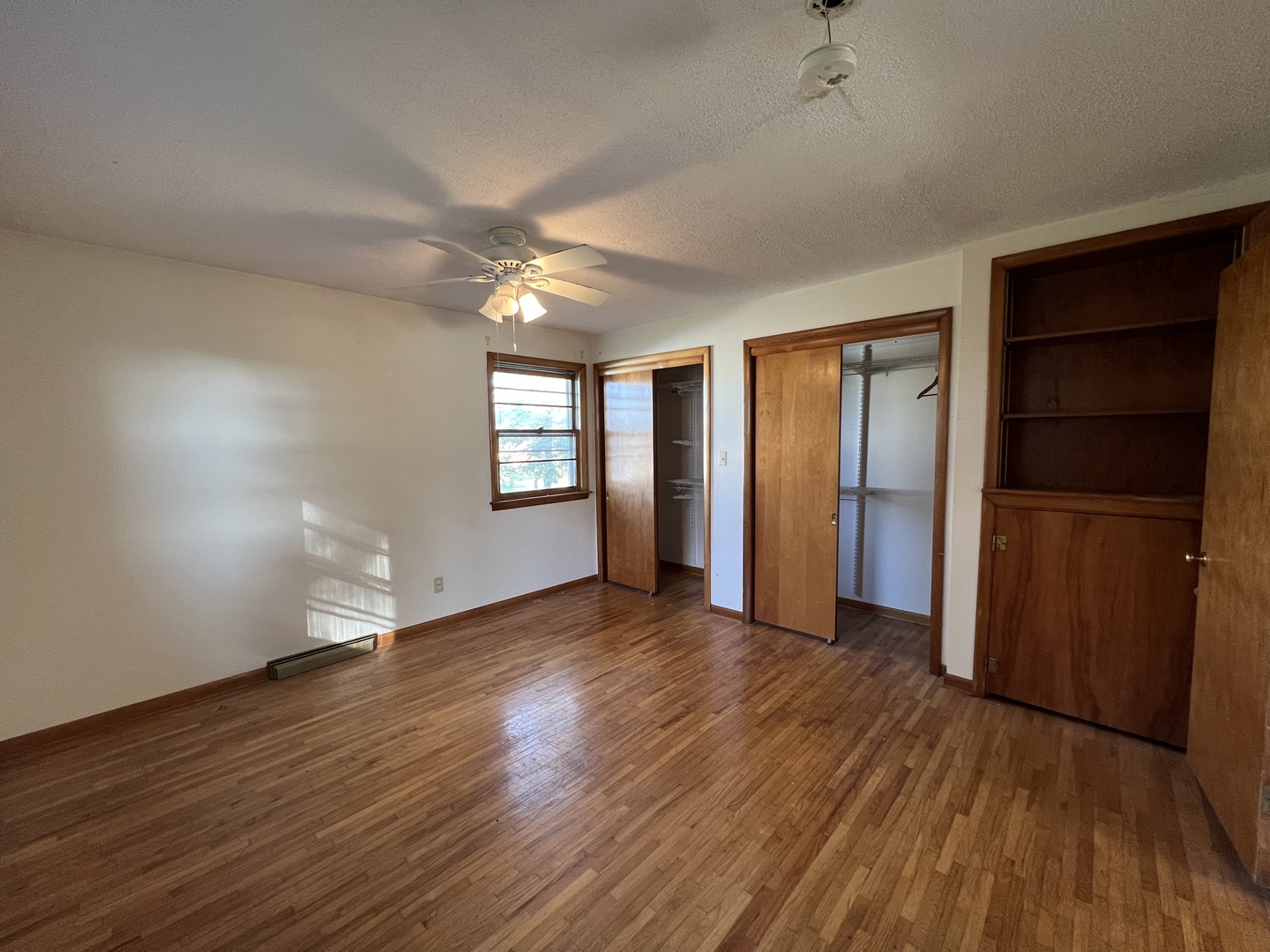 48W137 Middleton Road Maple Park, IL 60151 - Photo 5 of 27 an empty room with wooden floor cabinet and windows