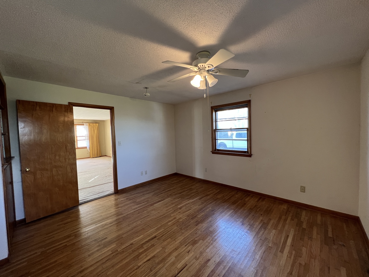 48W137 Middleton Road Maple Park, IL 60151 - Photo 6 of 27 a view of an empty room with window and wooden floor