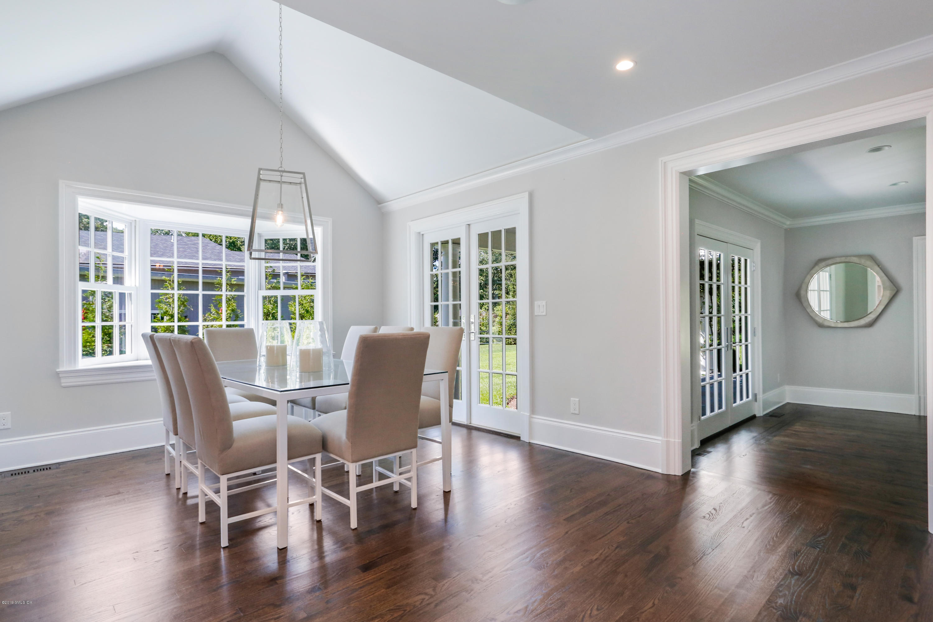 101 Dingletown Road Greenwich, CT 06830 - Photo 12 of 40 a dining room with wooden floor a glass table and chairs