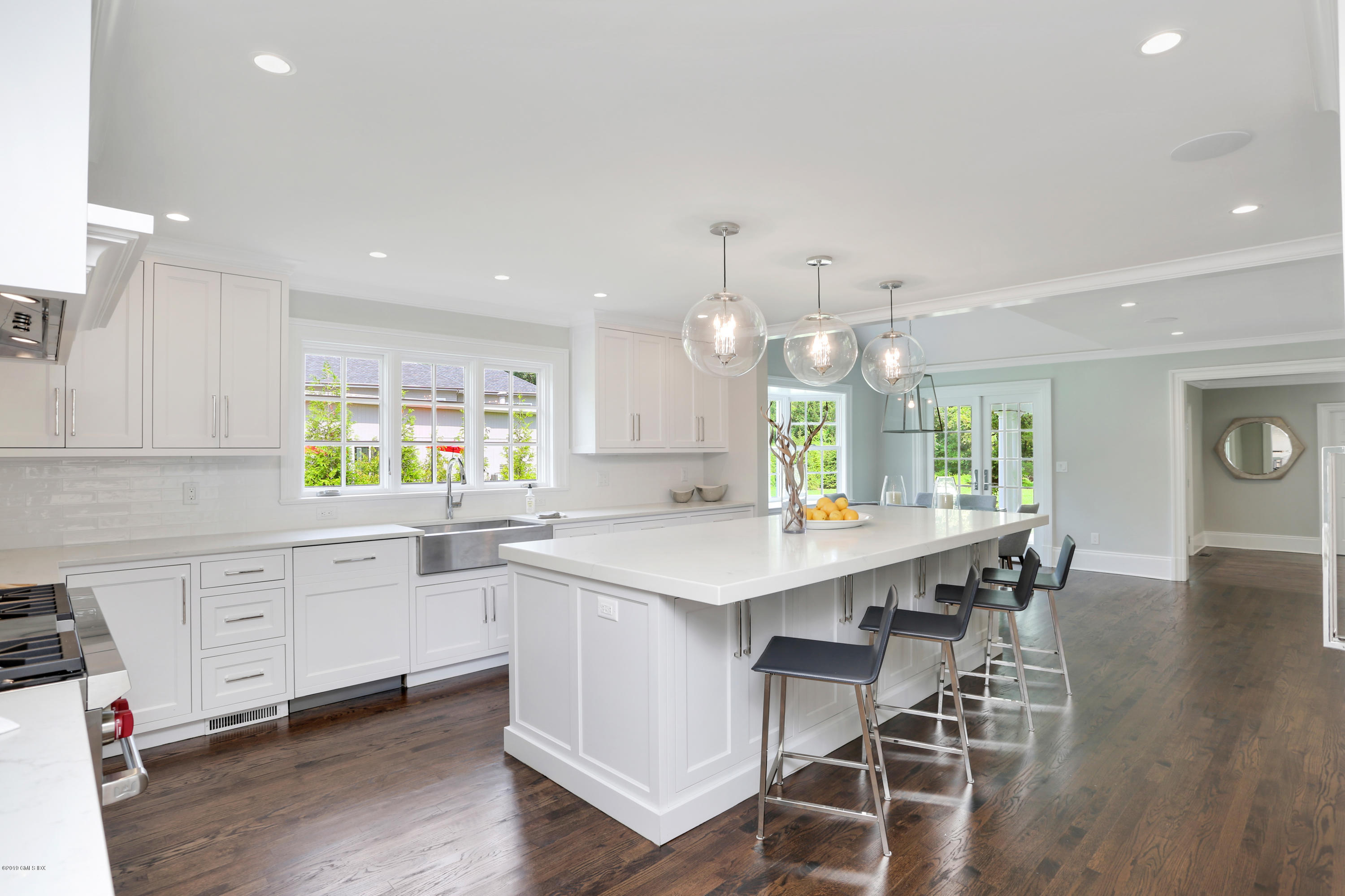 101 Dingletown Road Greenwich, CT 06830 - Photo 13 of 40 a kitchen with a dining table chairs wooden cabinets and white appliances