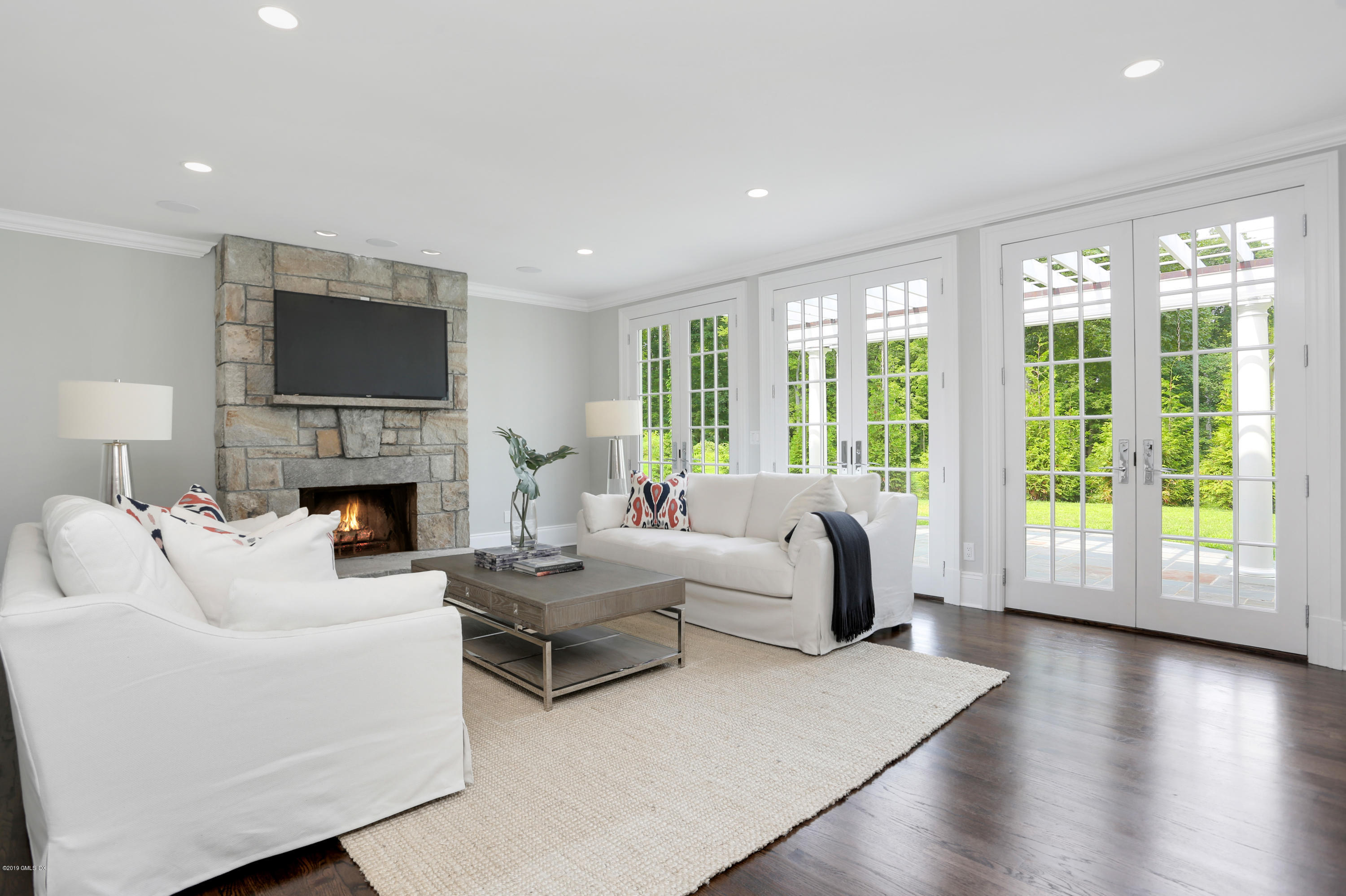 101 Dingletown Road Greenwich, CT 06830 - Photo 15 of 40 a living room with fireplace furniture and a large window