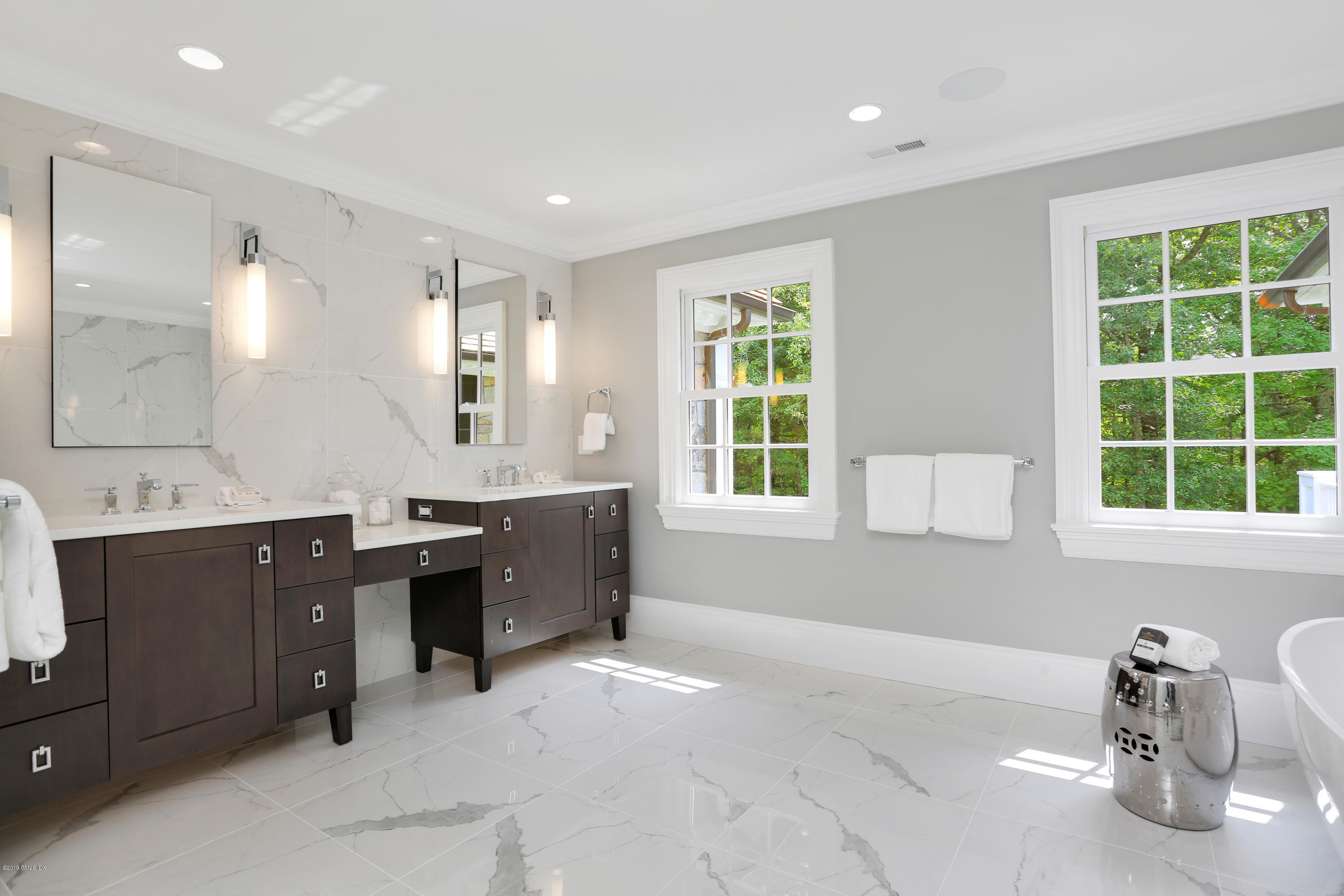 101 Dingletown Road Greenwich, CT 06830 - Photo 24 of 40 a spacious bathroom with a double vanity sink a mirror and a bathtub