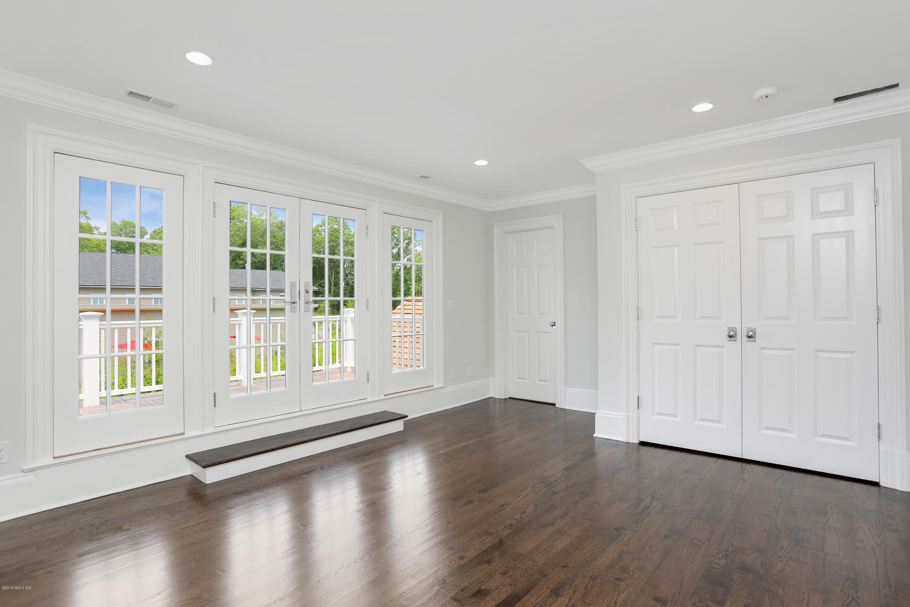 101 Dingletown Road Greenwich, CT 06830 - Photo 27 of 40 a view of an empty room with a window and wooden floor
