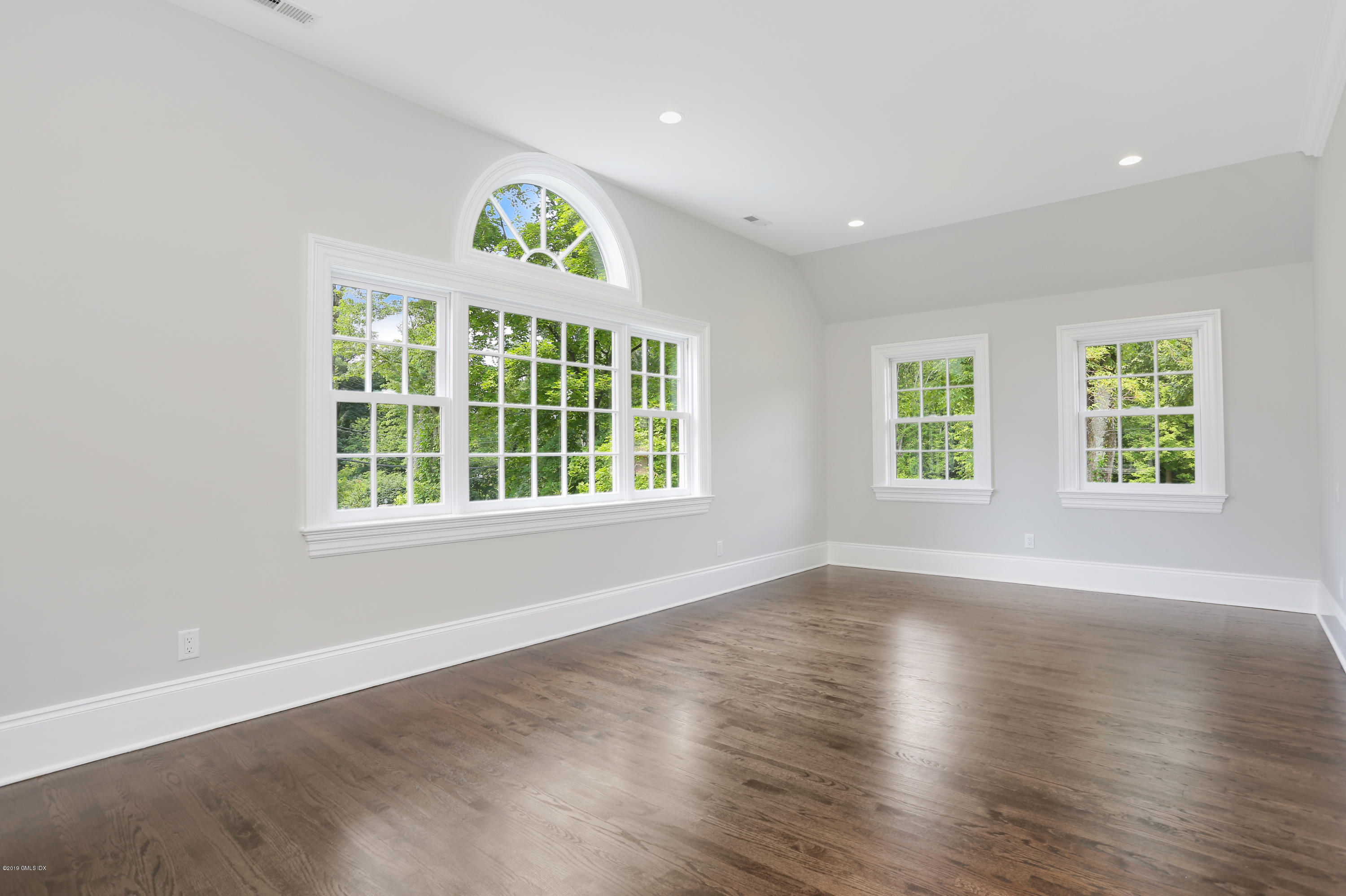 101 Dingletown Road Greenwich, CT 06830 - Photo 29 of 40 an empty room with wooden floor and windows