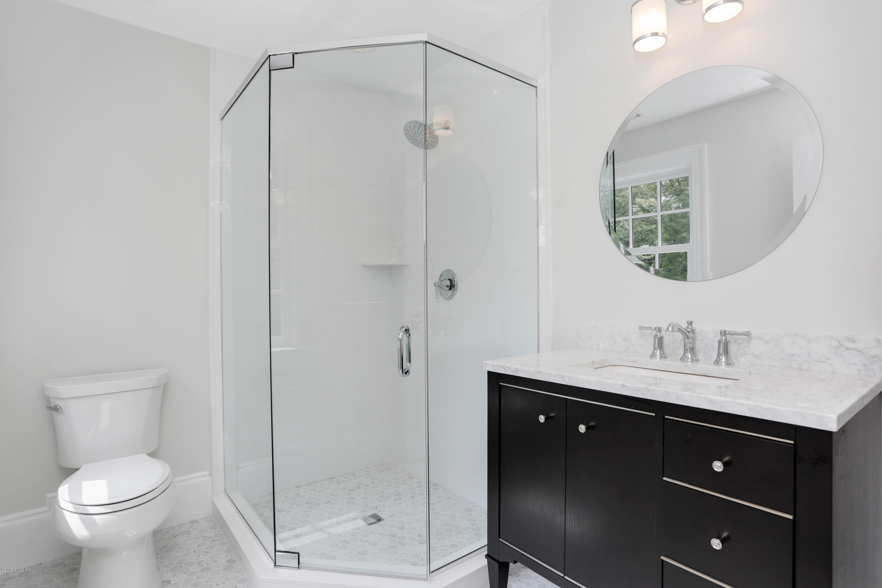 101 Dingletown Road Greenwich, CT 06830 - Photo 31 of 40 a bathroom with a toilet sink vanity and mirror