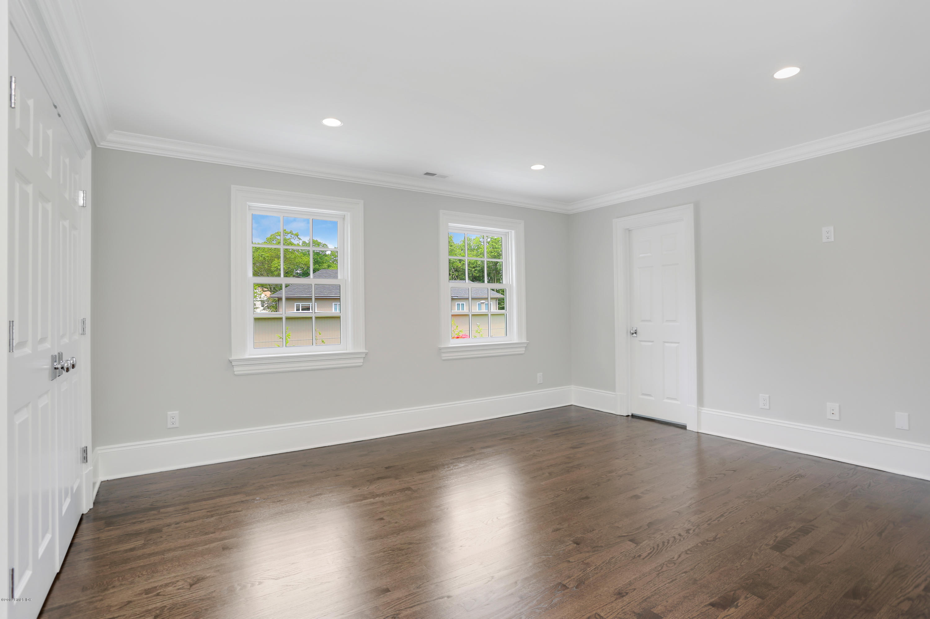 101 Dingletown Road Greenwich, CT 06830 - Photo 32 of 40 an empty room with wooden floor and windows