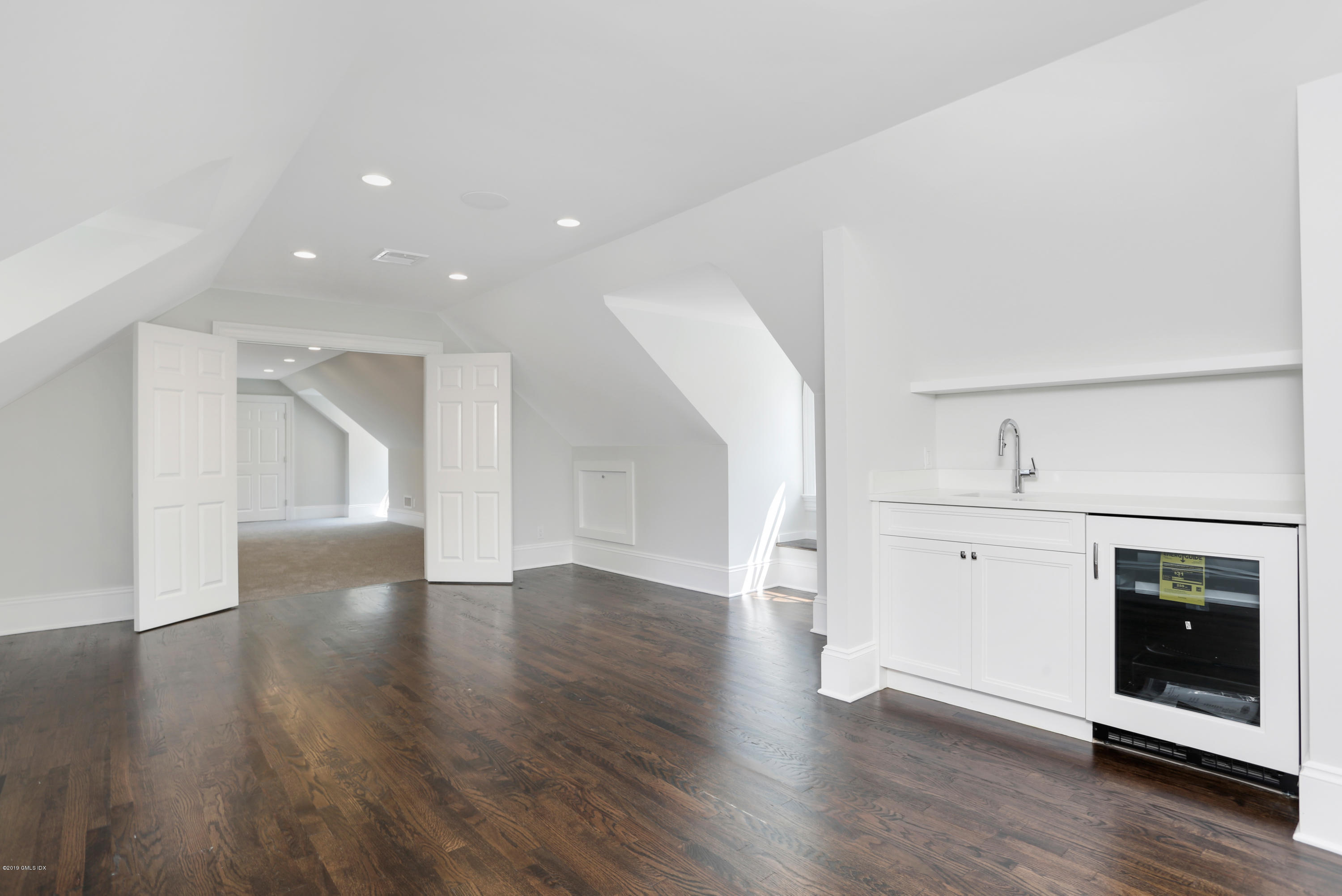 101 Dingletown Road Greenwich, CT 06830 - Photo 34 of 40 a view of an empty room with wooden floor and a window