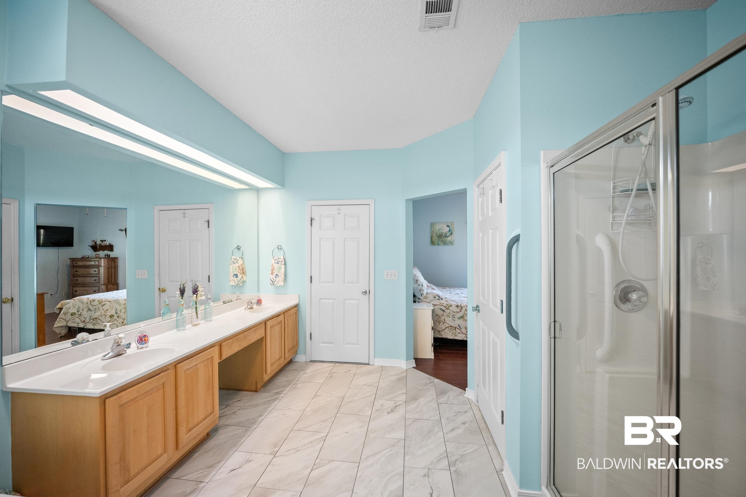22355 East County Road 12 Foley, AL 36535 - Photo 32 of 54 Bathroom with ensuite bathroom, double vanity, light marble finish flooring, a shower stall, and a textured ceiling