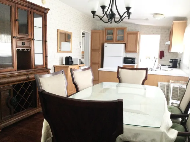 a view of a dining room with furniture and a chandelier