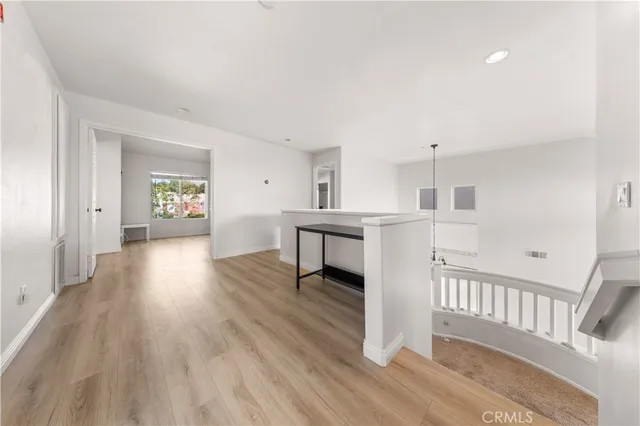 a view of a kitchen with wooden floor and electronic appliances