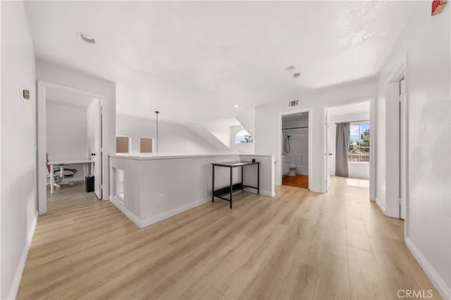 a view of a livingroom with wooden floor and a furniture
