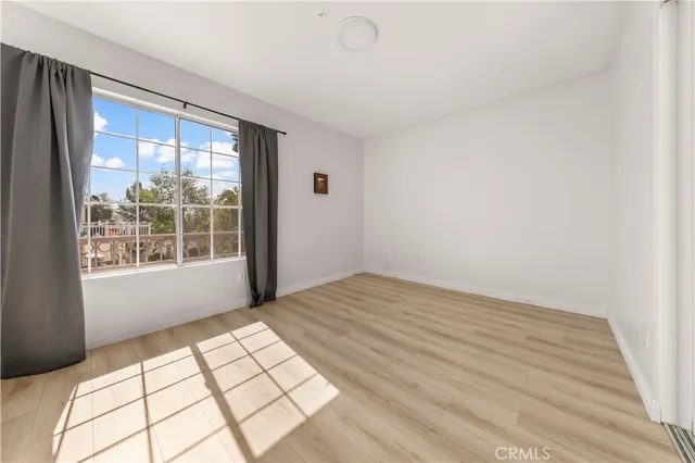 a view of wooden floor and windows in a room