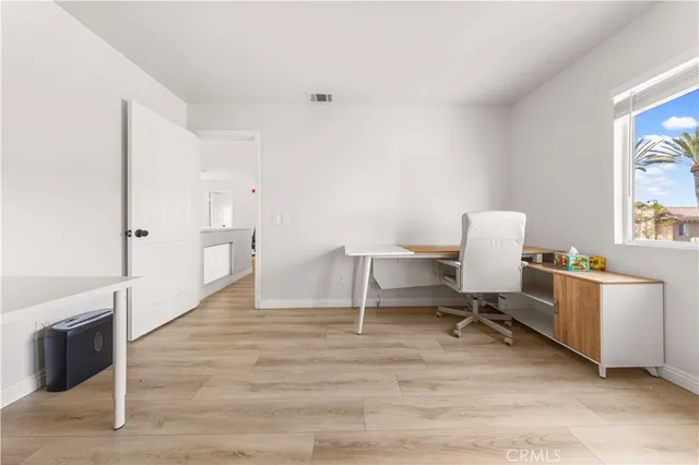 a view of a workspace with furniture and a fireplace