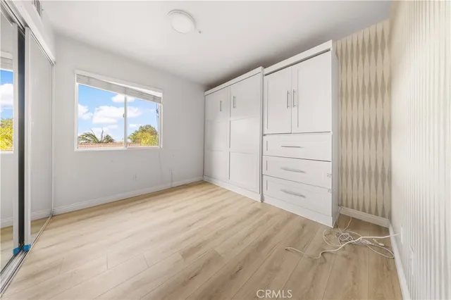 an empty room with windows and closet