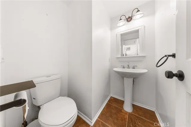 a white toilet sitting next to a bathroom sink
