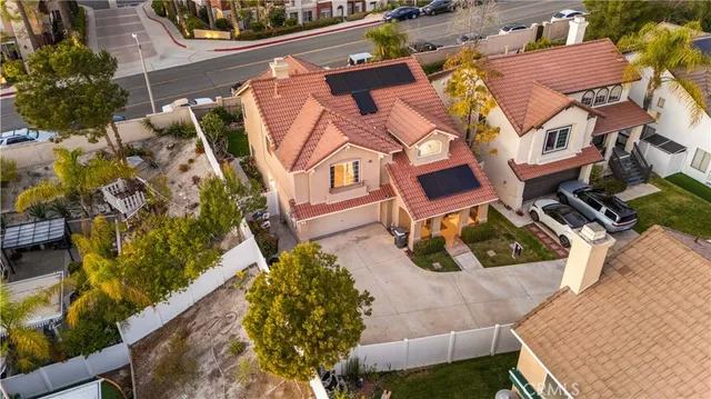 an aerial view of a house with a yard