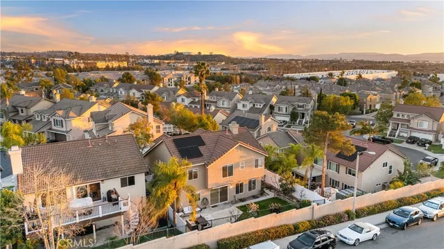 an aerial view of residential houses with city view