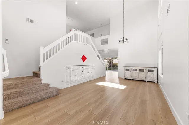 a view of a bedroom with wooden floor and windows