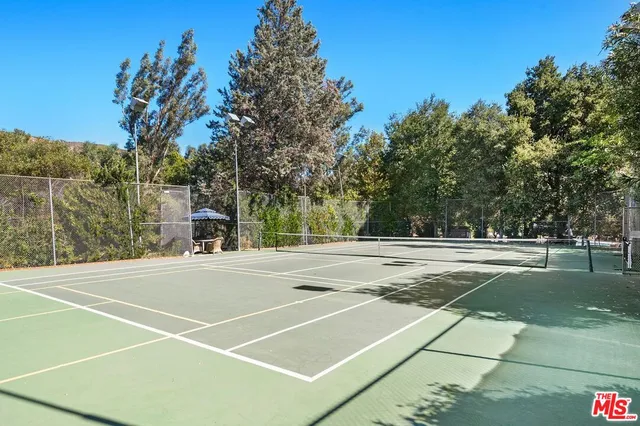 a picture of a bathroom with a white wall and a picture of the view of a house