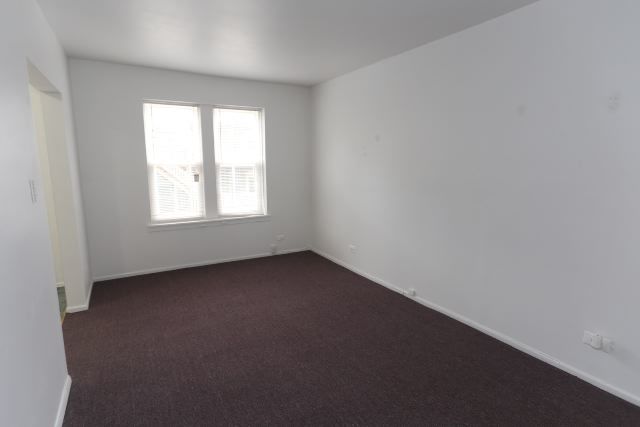 4515 North Malden Street, Unit 1C Chicago, IL 60640 - Photo 11 of 16 an empty room with a window