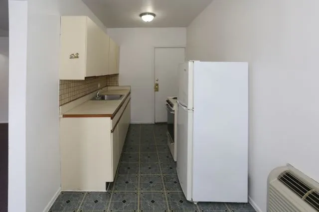 a utility room with wooden floor washer and dryer