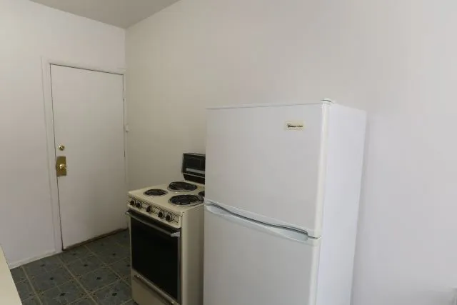 a kitchen with a stove and a refrigerator