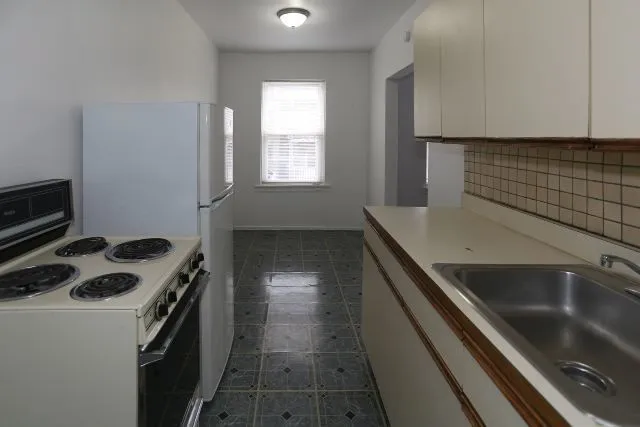 a kitchen that has a sink and a stove
