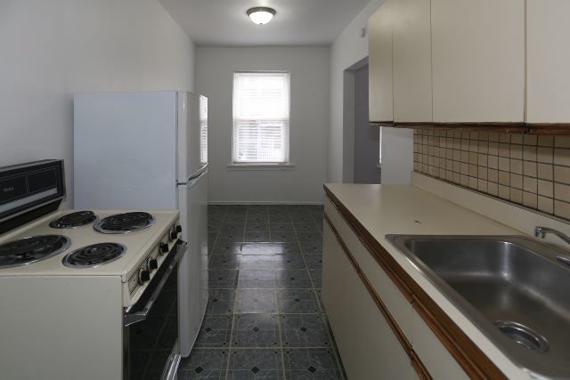 4515 North Malden Street, Unit 1C Chicago, IL 60640 - Photo 5 of 16 a kitchen that has a sink and a stove