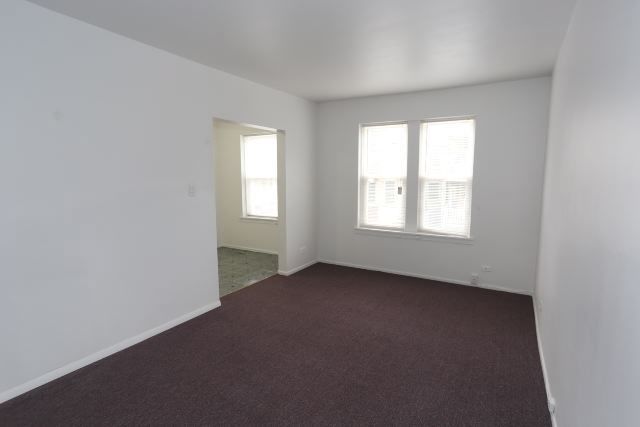 4515 North Malden Street, Unit 1C Chicago, IL 60640 - Photo 9 of 16 an empty room with windows