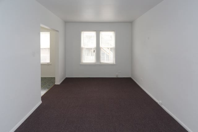 4515 North Malden Street, Unit 1C Chicago, IL 60640 - Photo 10 of 16 an empty room with a window