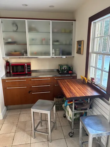 a room with pool table and two windows