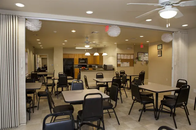 a large kitchen with a dining table and chairs