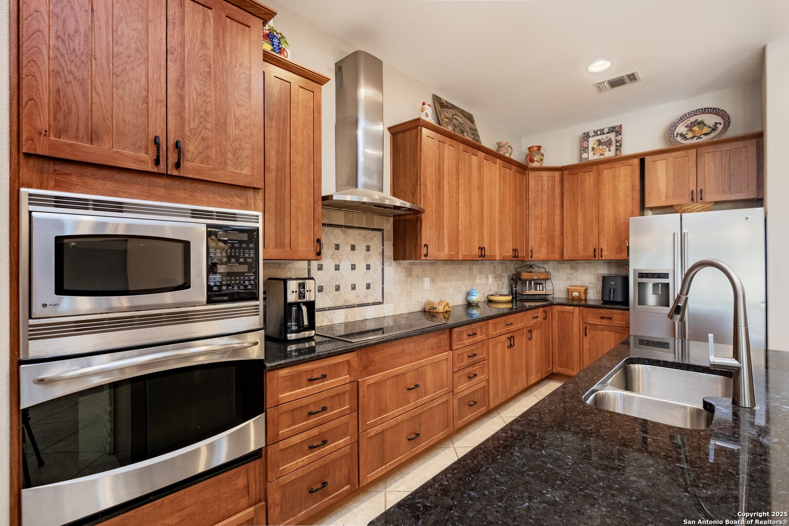 233 N Fork Bandera, TX 78003 - Photo 12 of 71 a kitchen with stainless steel appliances granite countertop a stove a sink and a microwave