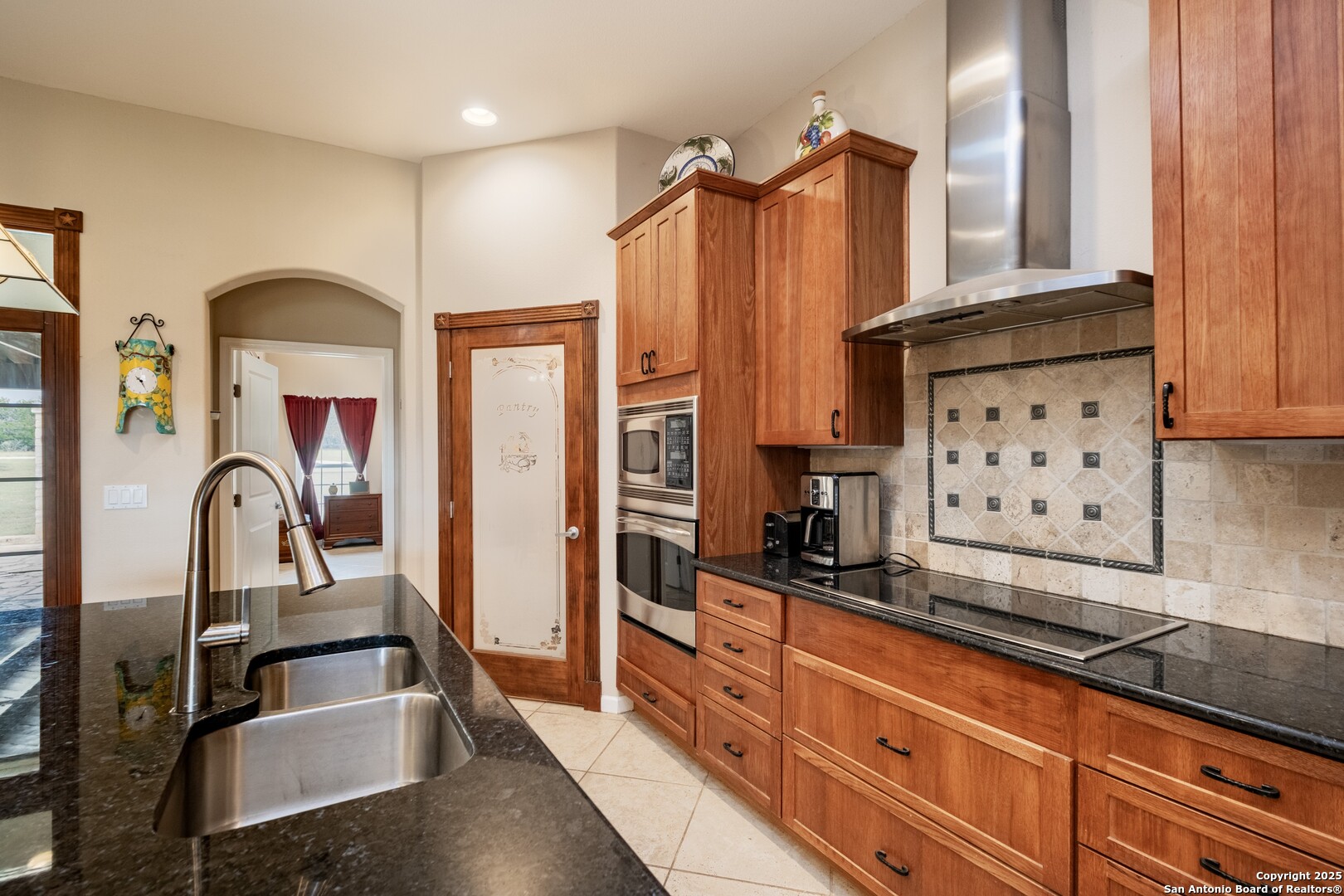 233 N Fork Bandera, TX 78003 - Photo 13 of 71 a kitchen with granite countertop a refrigerator and a sink