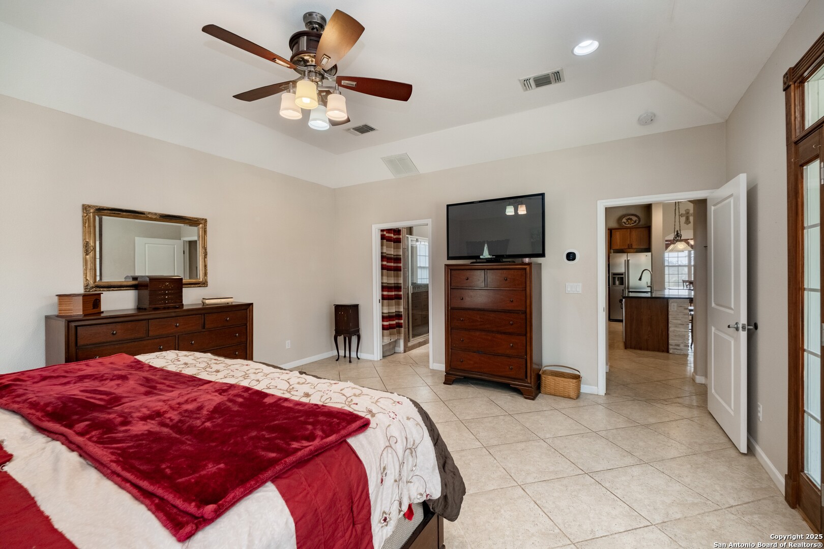 233 N Fork Bandera, TX 78003 - Photo 19 of 71 a bedroom with a bed and a chandelier