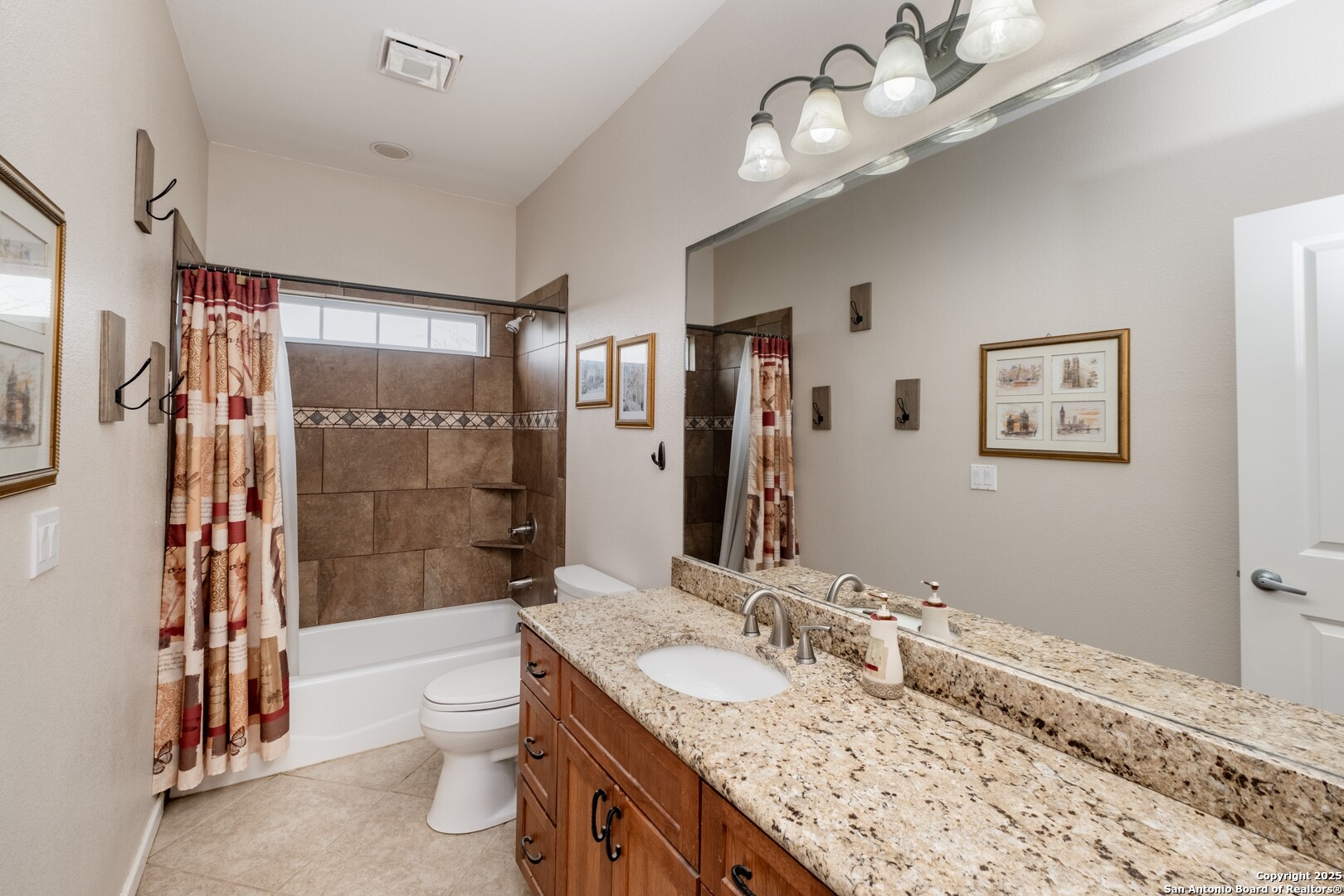 233 N Fork Bandera, TX 78003 - Photo 26 of 71 a bathroom with a granite countertop sink a toilet a mirror and shower