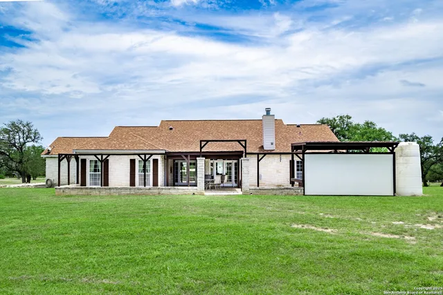 a view of a dining room with furniture wooden floor and a kitchen