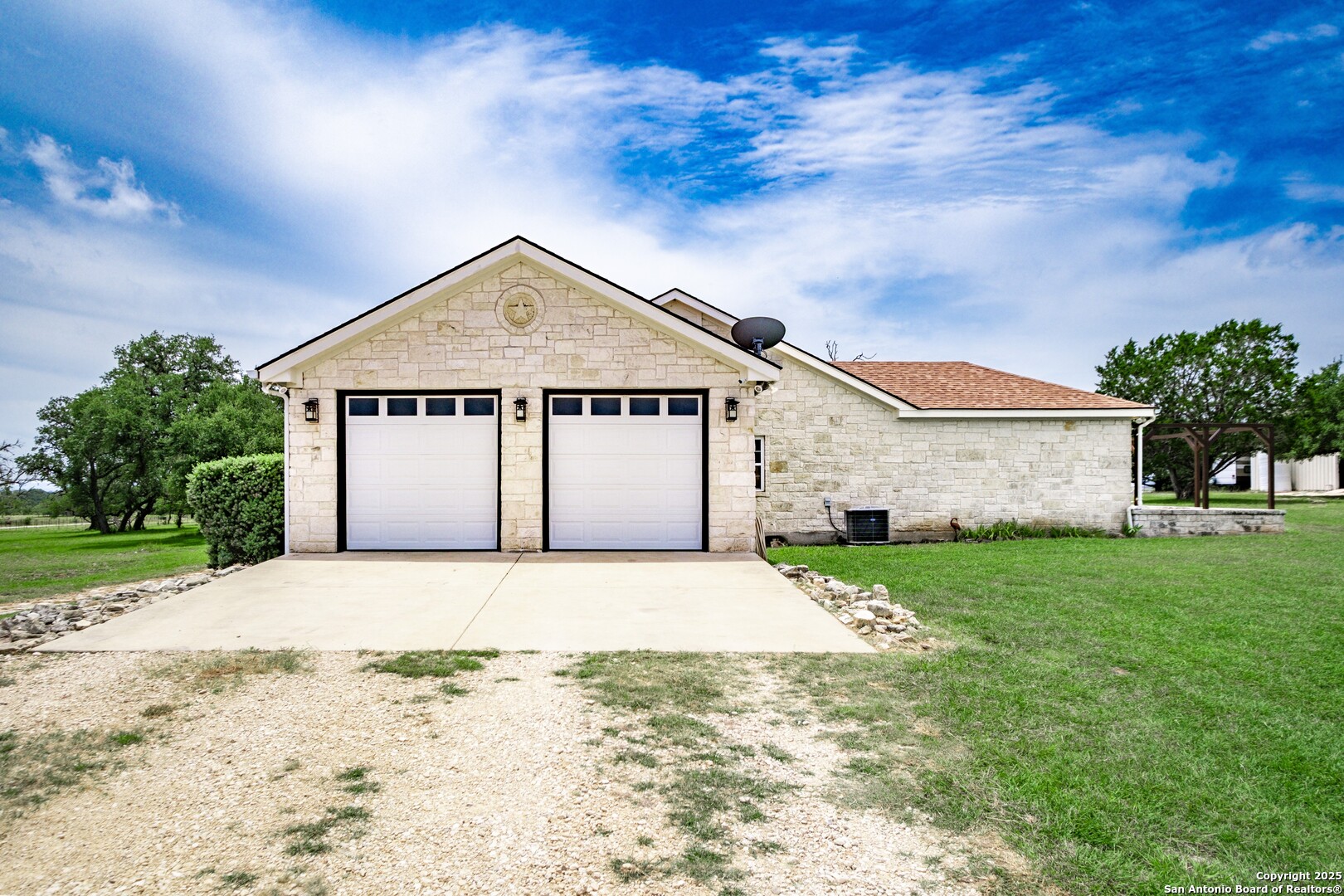233 N Fork Bandera, TX 78003 - Photo 35 of 71 a front view of a house with a yard and garage