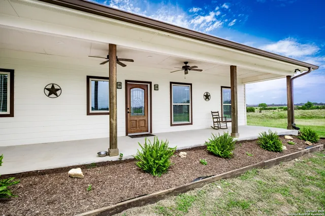 a bathroom with a granite countertop sink a toilet and a mirror