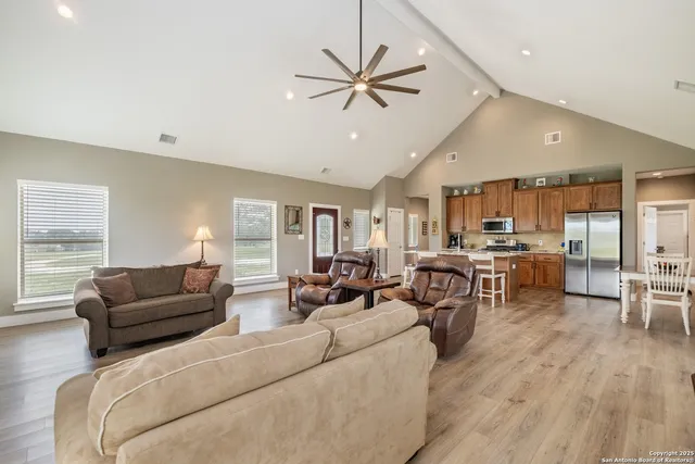 a bathroom with a granite countertop sink toilet and mirror