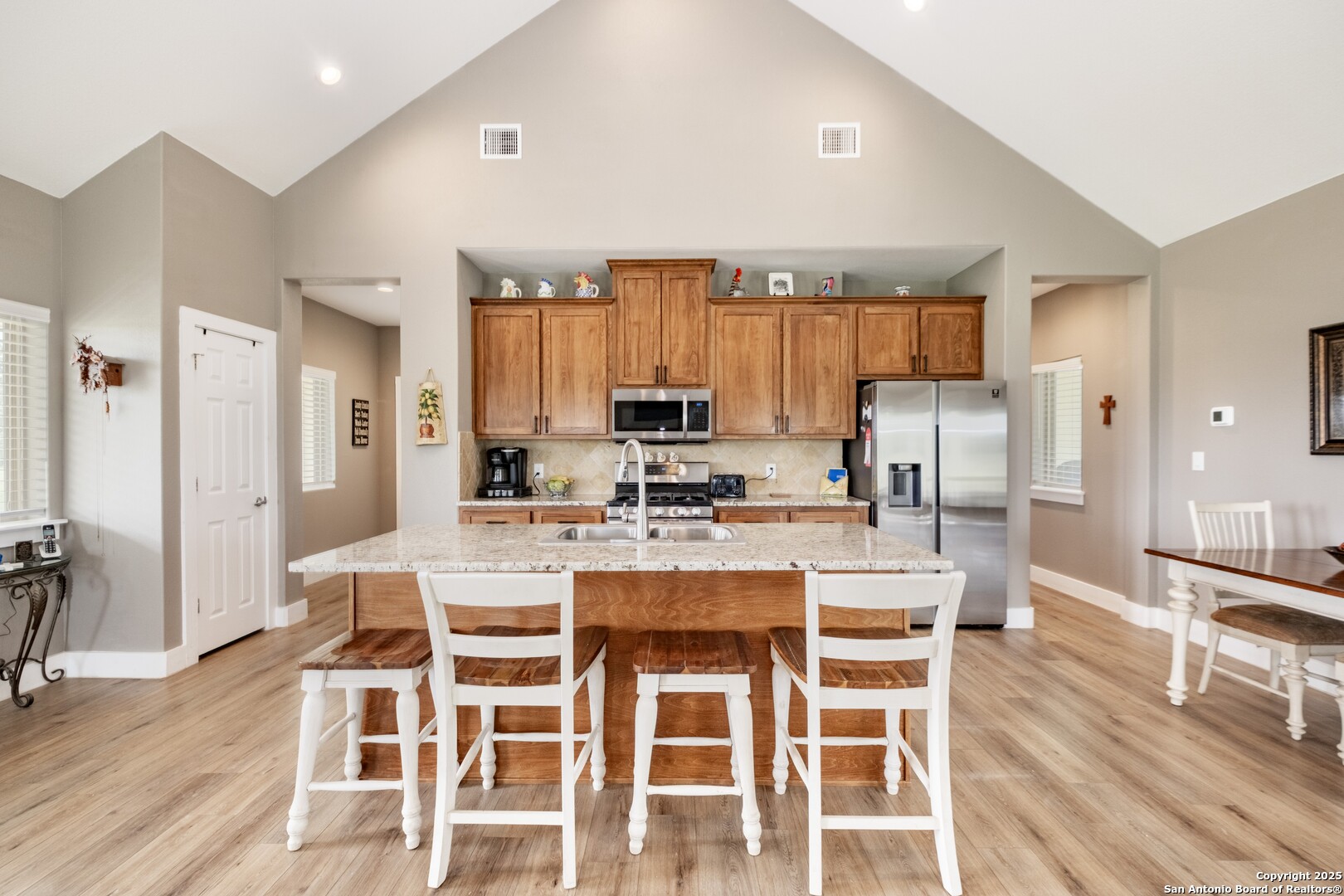 233 N Fork Bandera, TX 78003 - Photo 44 of 71 a view of a dining room with furniture wooden floor and a kitchen