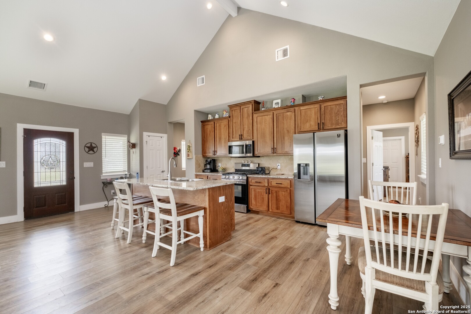 233 N Fork Bandera, TX 78003 - Photo 45 of 71 a kitchen with stainless steel appliances a dining table chairs and wooden floor
