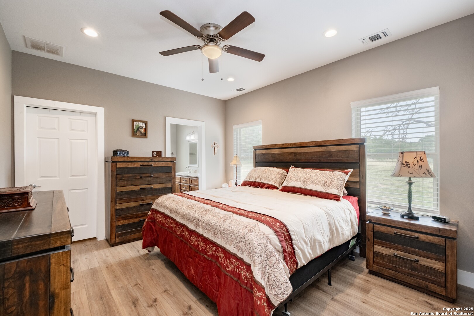 233 N Fork Bandera, TX 78003 - Photo 50 of 71 a bedroom with a bed and a chandelier