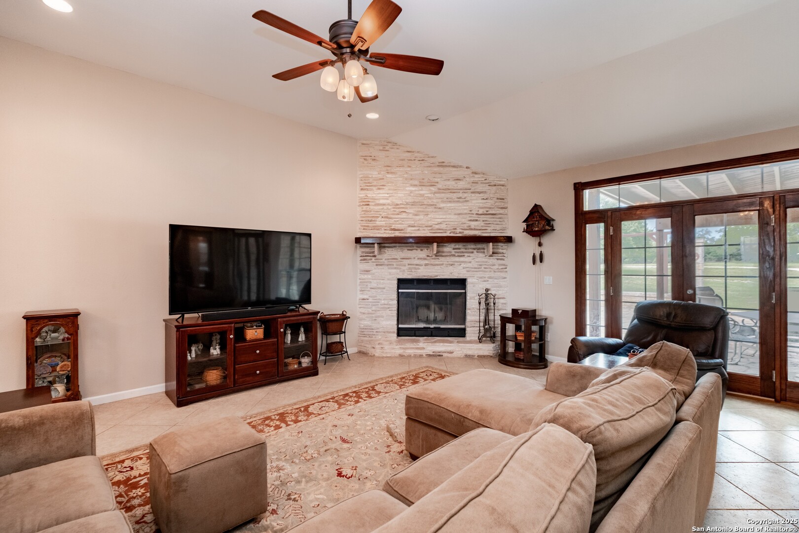 233 N Fork Bandera, TX 78003 - Photo 5 of 71 a living room with furniture a fireplace a flat screen tv and a large window