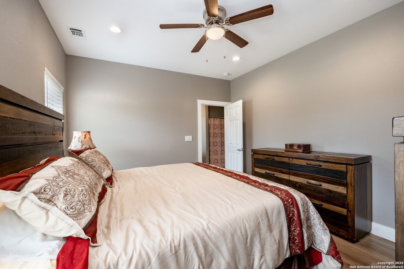 233 N Fork Bandera, TX 78003 - Photo 51 of 71 a bedroom with a bed and a chandelier
